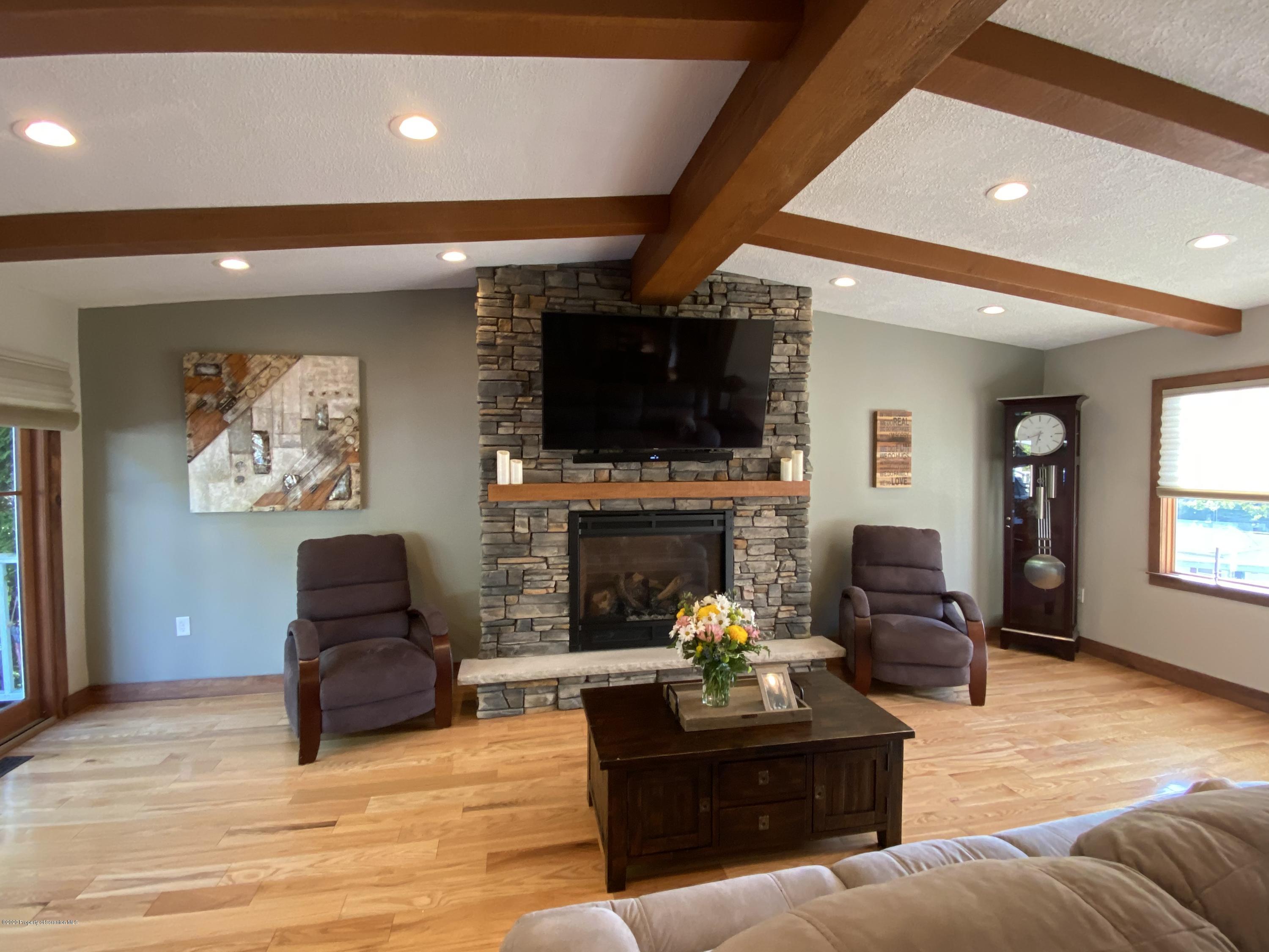 225 Terrace Street Shavertown, PA 18708 - Photo 13 of 19 a living room with furniture a fireplace and a flat screen tv
