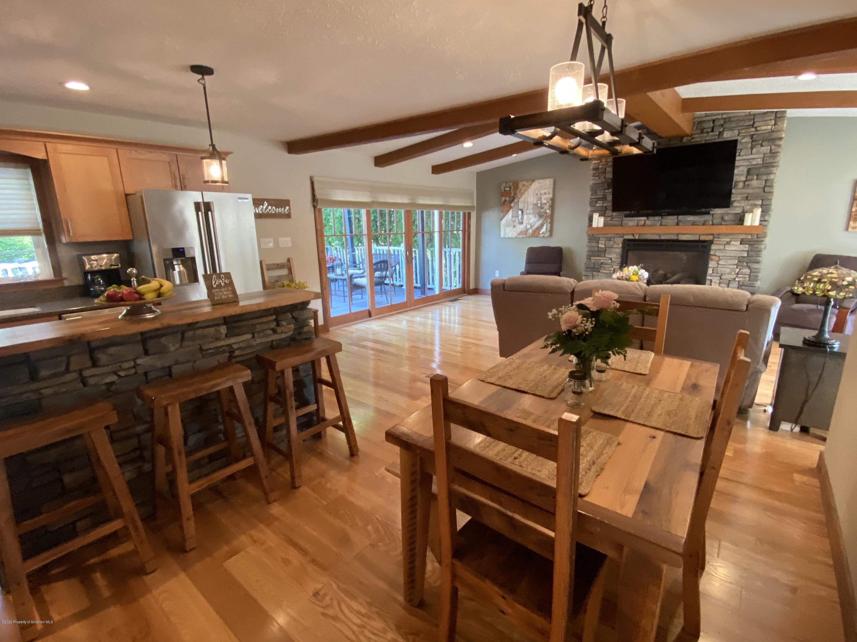 225 Terrace Street Shavertown, PA 18708 - Photo 15 of 19 a view of a dining room with furniture a chandelier and wooden floor