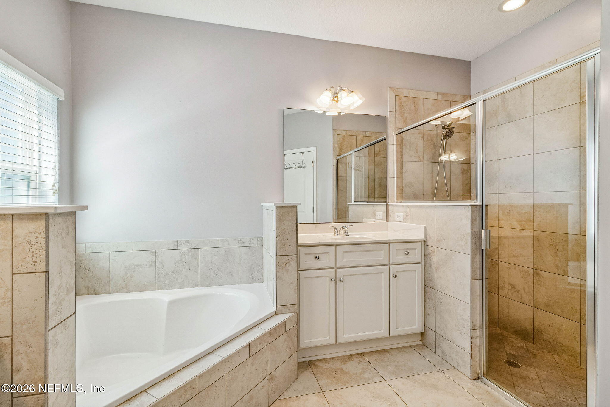 96048 Breezeway Court Yulee, FL 32097 - Photo 17 of 26 a bathroom with a bathtub and a sink