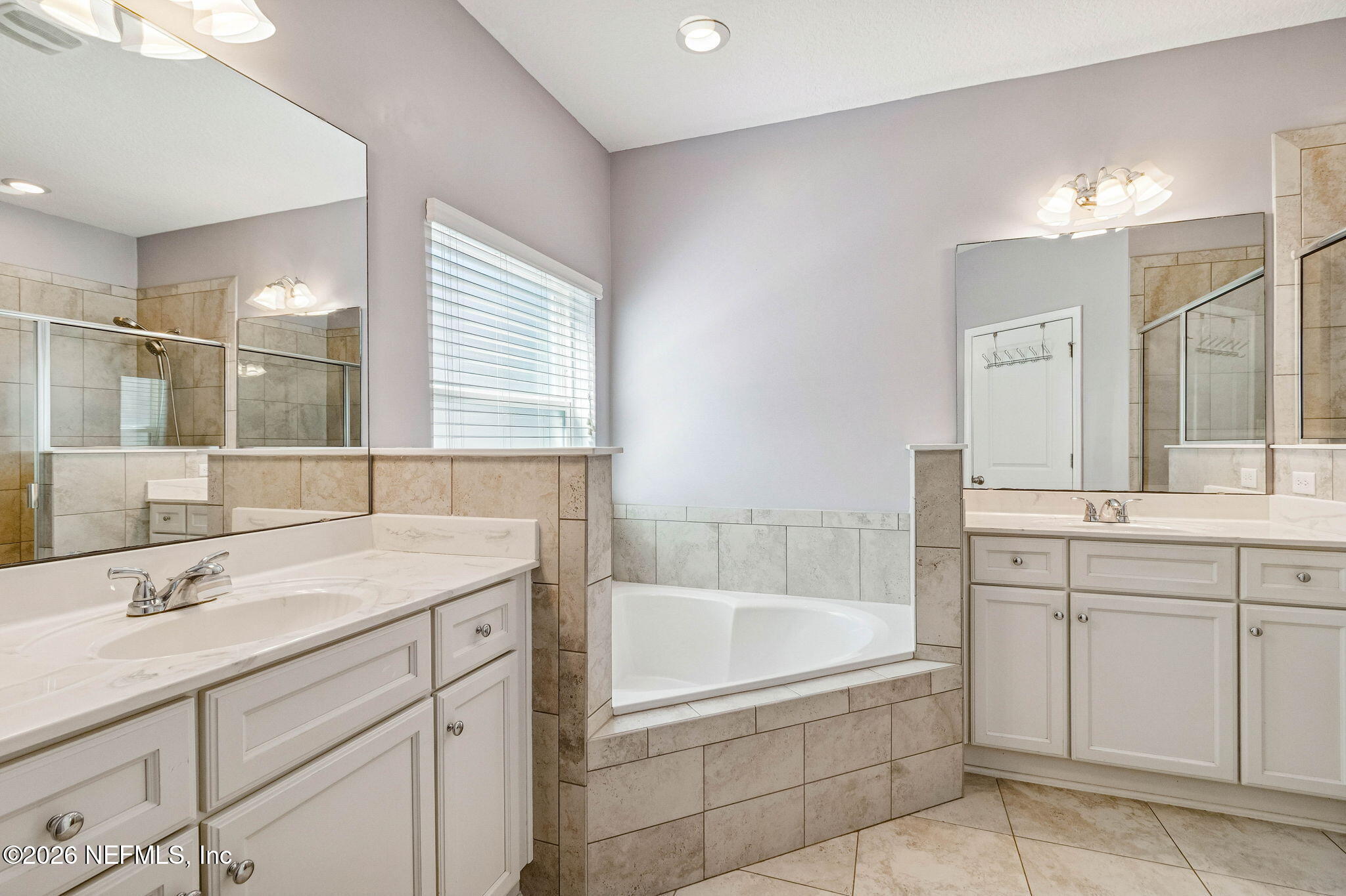 96048 Breezeway Court Yulee, FL 32097 - Photo 18 of 26 a bathroom with a tub sink and mirror