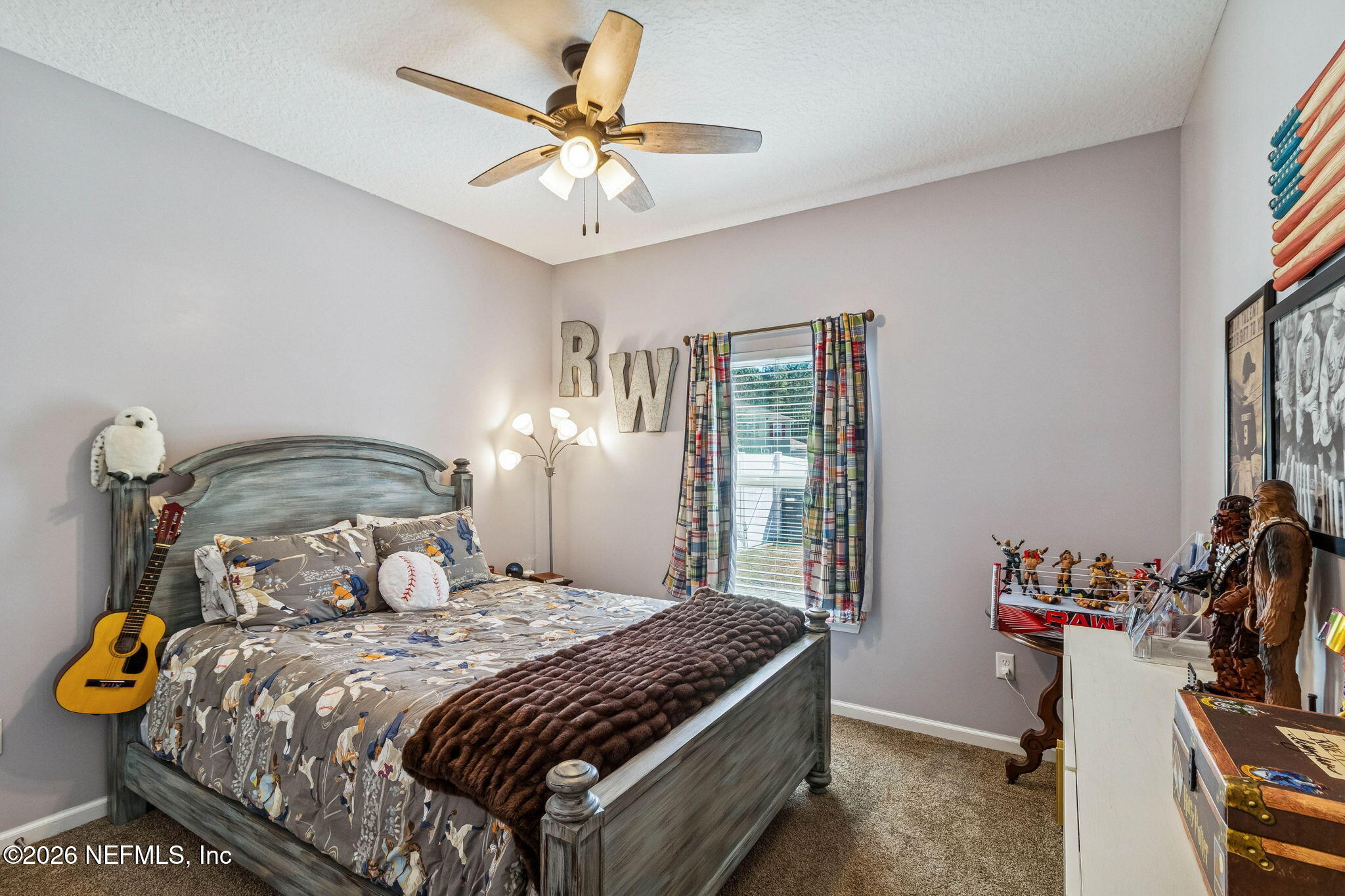 96048 Breezeway Court Yulee, FL 32097 - Photo 21 of 26 a bedroom with a bed and a chandelier