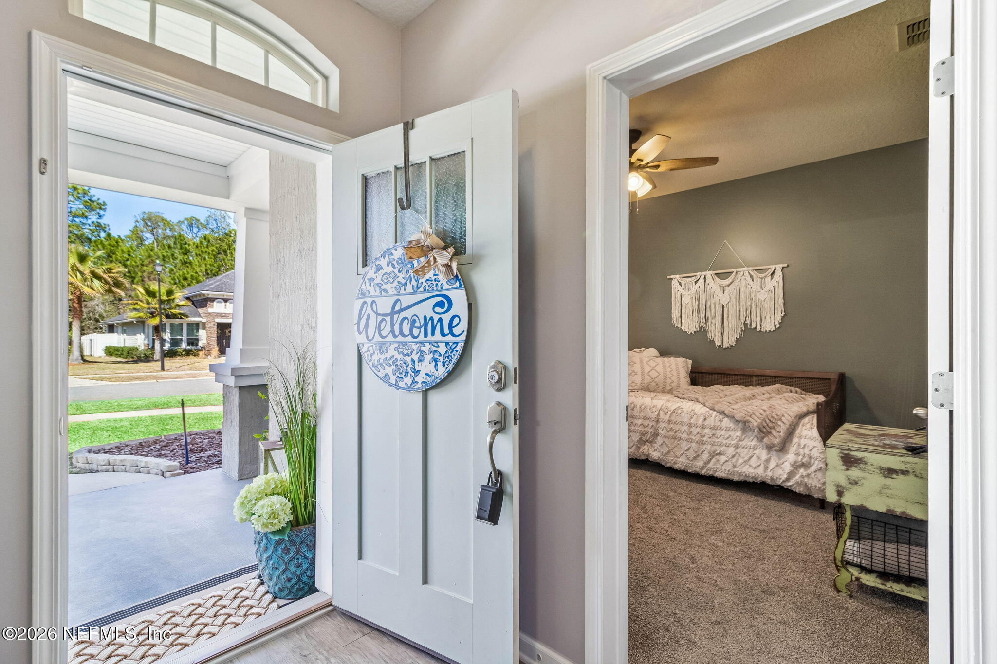 96048 Breezeway Court Yulee, FL 32097 - Photo 24 of 26 a bedroom with a bed and a window