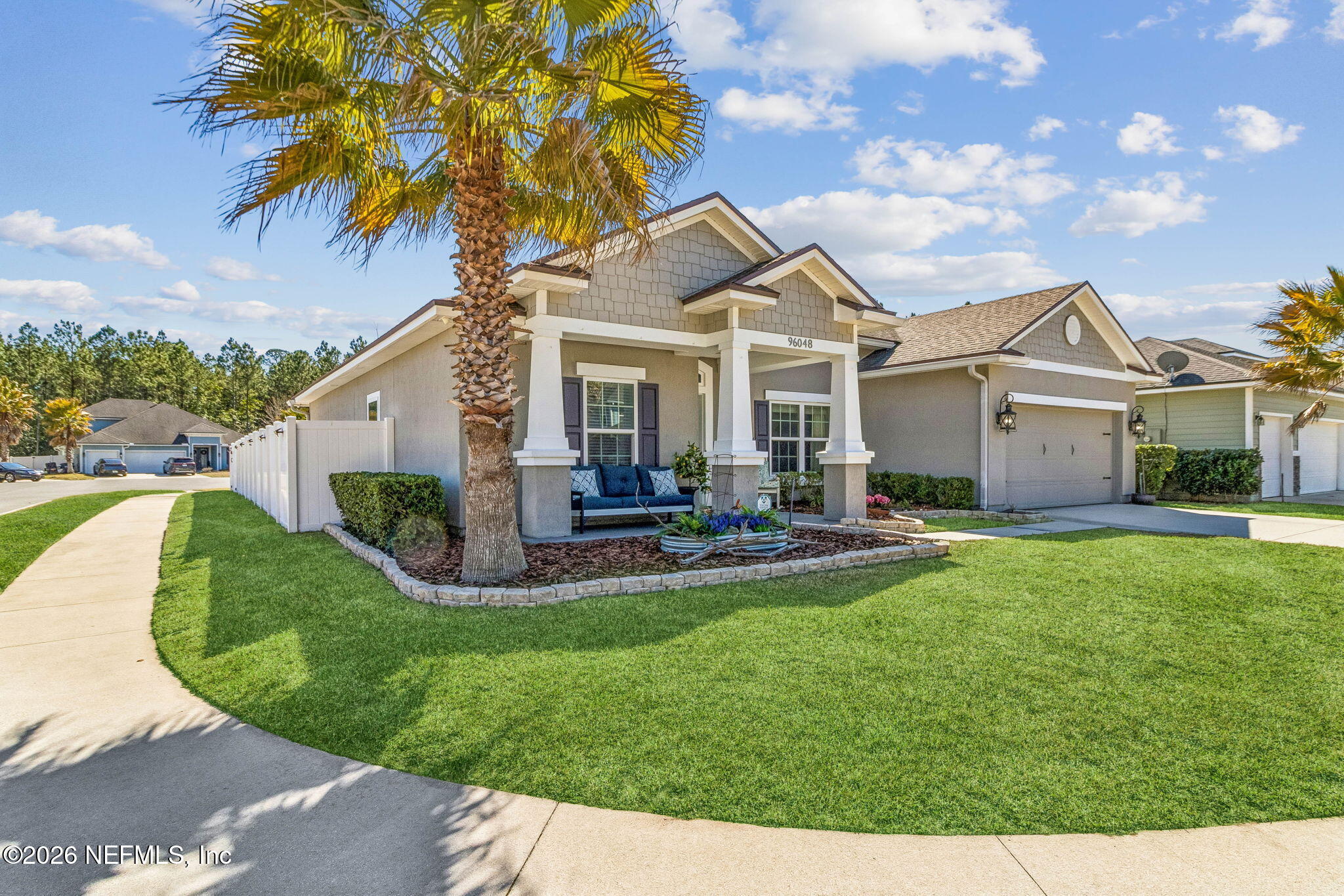 96048 Breezeway Court Yulee, FL 32097 - Photo 25 of 26 a view of a house with sitting area and garden