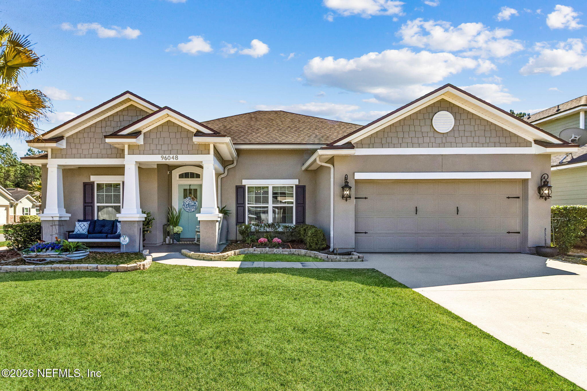 96048 Breezeway Court Yulee, FL 32097 - Photo 26 of 26 a view of a small house in front of a big yard with plants and large tree