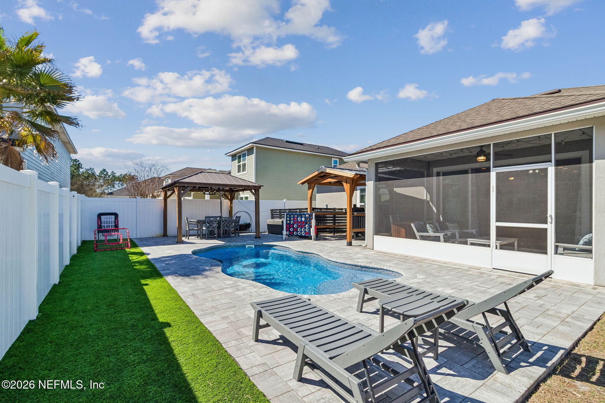 96048 Breezeway Court Yulee, FL 32097 - Photo 3 of 26 a view of a house with backyard porch and sitting area