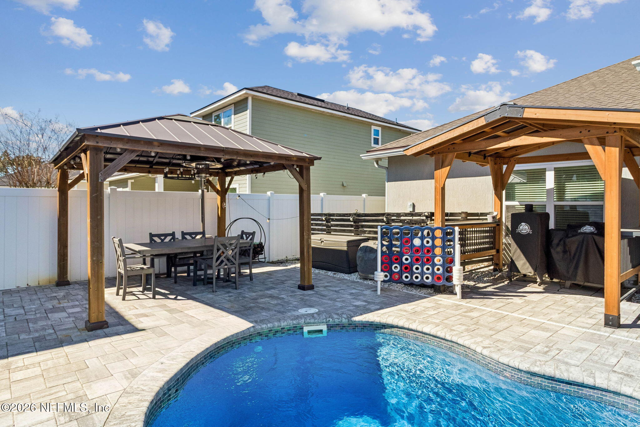 96048 Breezeway Court Yulee, FL 32097 - Photo 4 of 26 a view of a chairs and table in a patio
