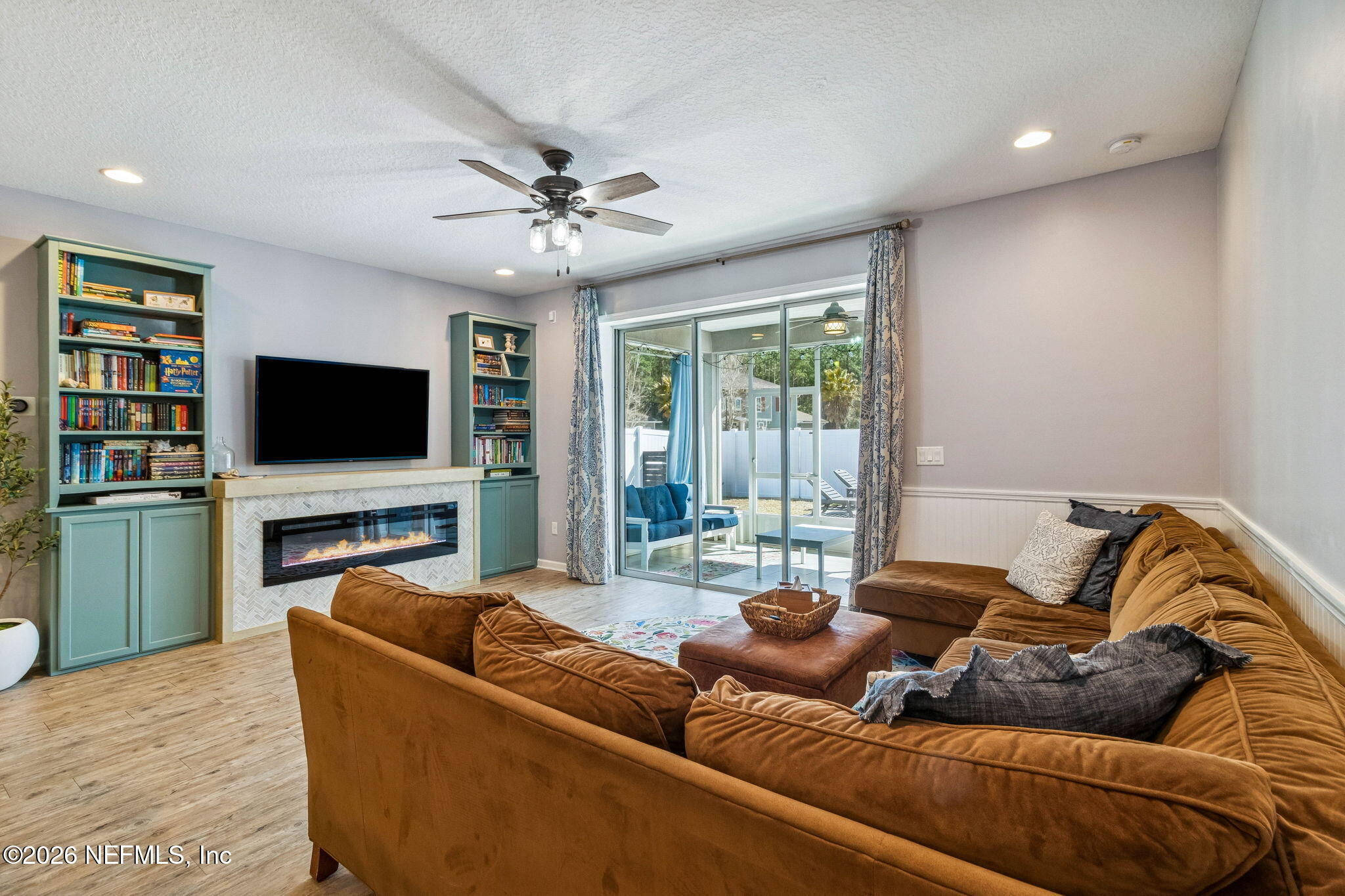 96048 Breezeway Court Yulee, FL 32097 - Photo 8 of 26 a living room with furniture and a flat screen tv