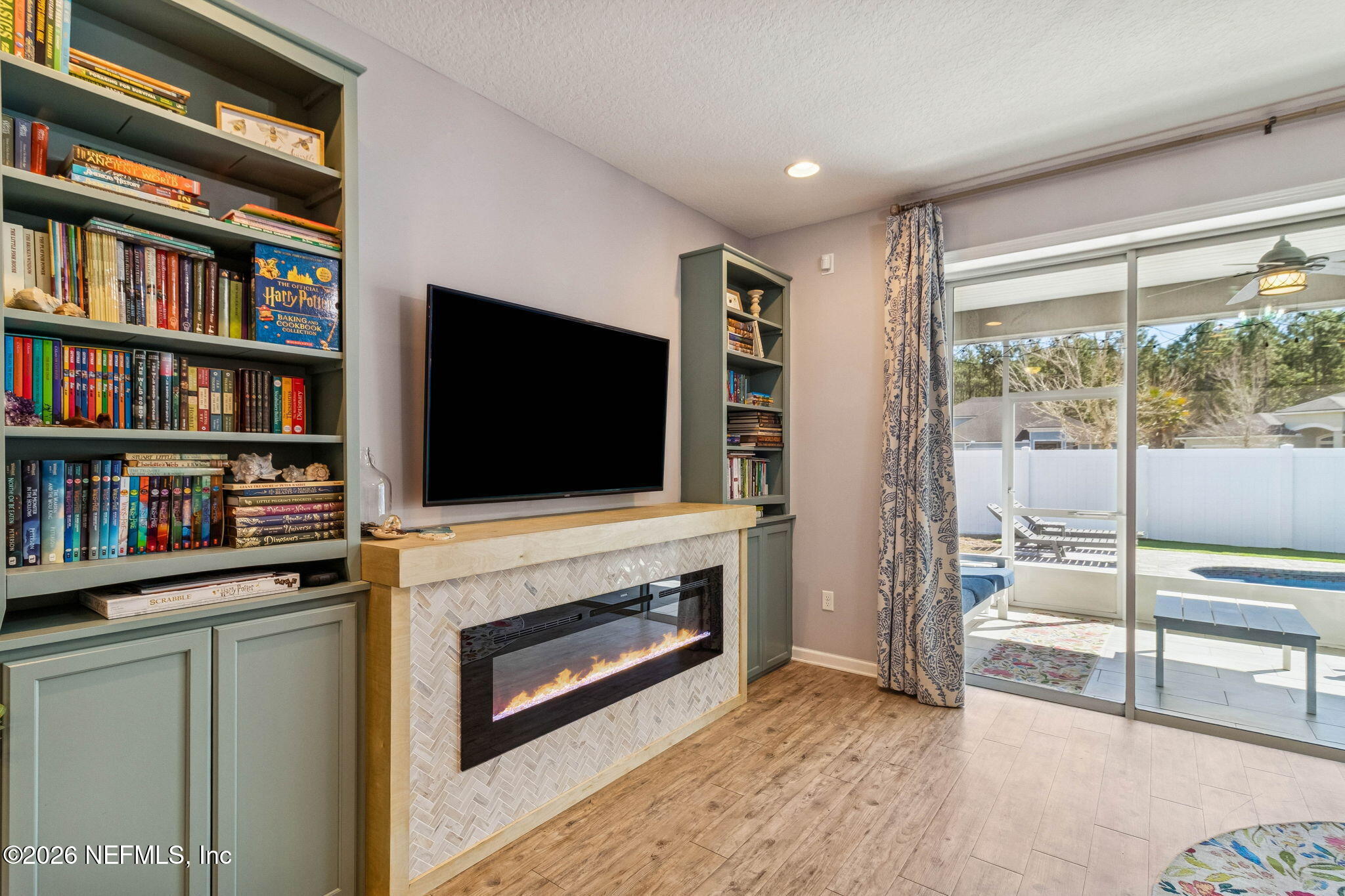 96048 Breezeway Court Yulee, FL 32097 - Photo 9 of 26 a living room with television and a fireplace