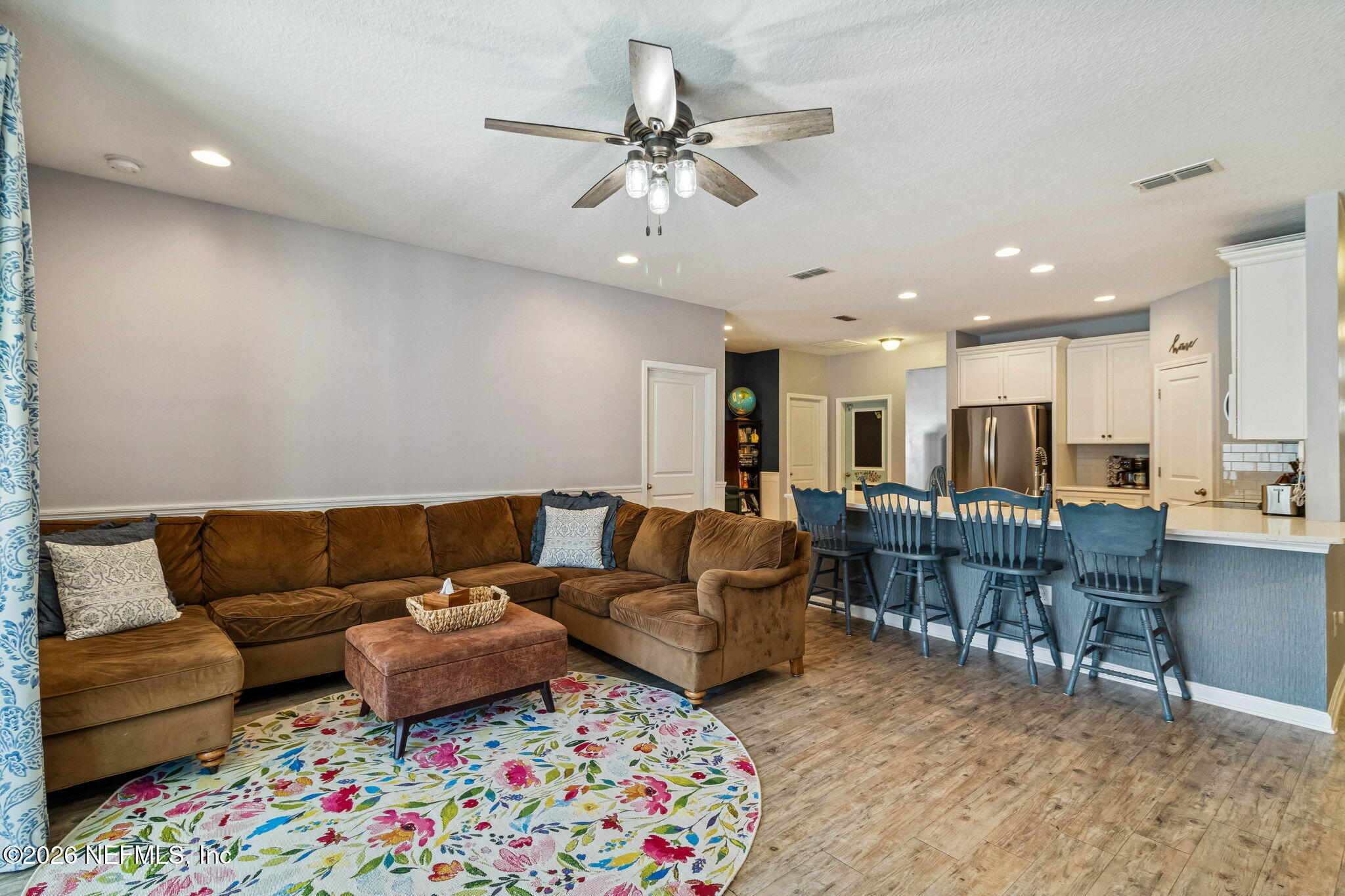 96048 Breezeway Court Yulee, FL 32097 - Photo 10 of 26 a living room with furniture and a dining table with kitchen view