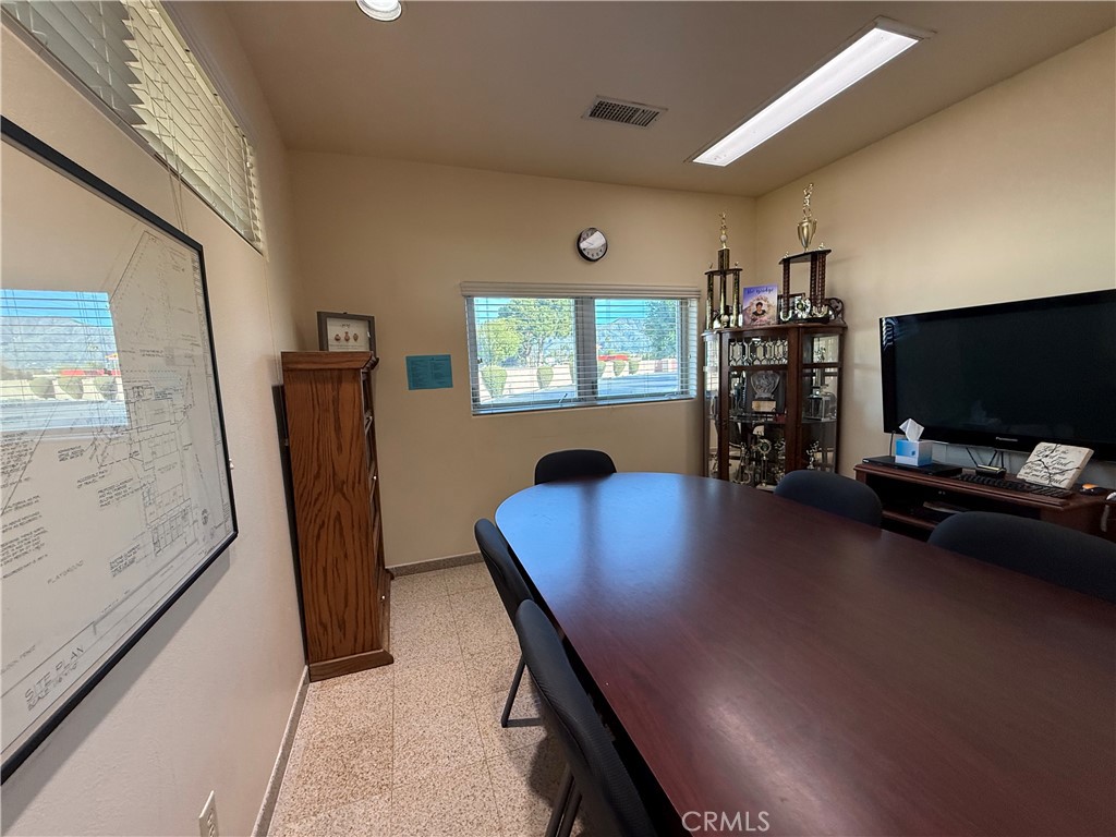 405 South Azusa Avenue Azusa, CA 91702 - Photo 17 of 70 a view of a workspace with furniture and a flat screen tv