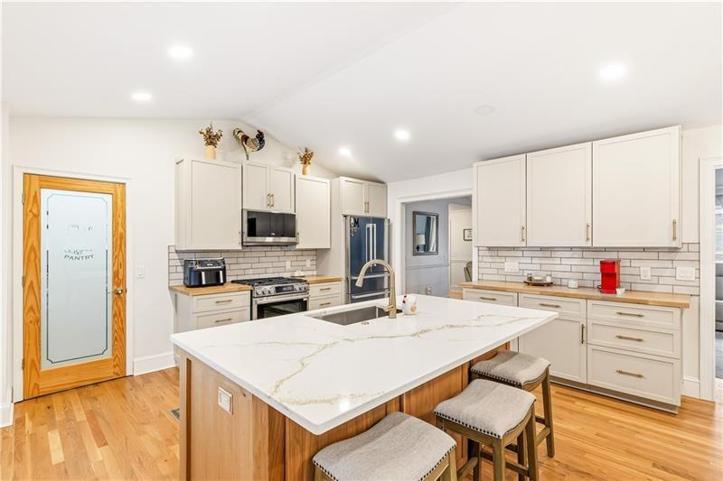 3890 Jim Owens Road Northwest Kennesaw, GA 30152 - Photo 14 of 43 a kitchen with stainless steel appliances kitchen island granite countertop a sink and cabinets