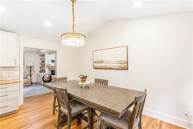 3890 Jim Owens Road Northwest Kennesaw, GA 30152 - Photo 15 of 43 a view of a dining room with furniture and wooden floor