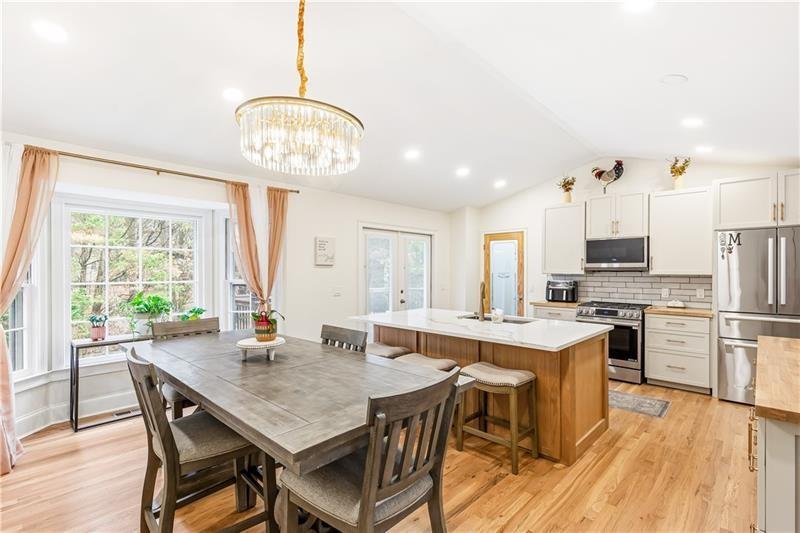 3890 Jim Owens Road Northwest Kennesaw, GA 30152 - Photo 16 of 43 a view of a dining room with furniture window and wooden floor