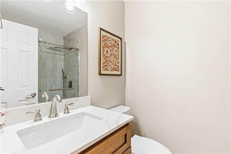 3890 Jim Owens Road Northwest Kennesaw, GA 30152 - Photo 19 of 43 a bathroom with a sink mirror vanity and toilet