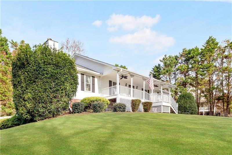 3890 Jim Owens Road Northwest Kennesaw, GA 30152 - Photo 2 of 43 a front view of a house with a garden