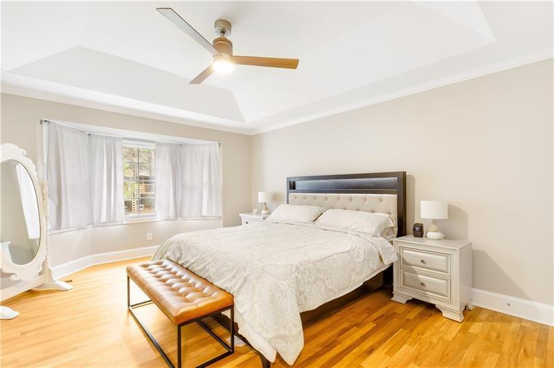 3890 Jim Owens Road Northwest Kennesaw, GA 30152 - Photo 25 of 43 a bedroom with a bed and wooden floor