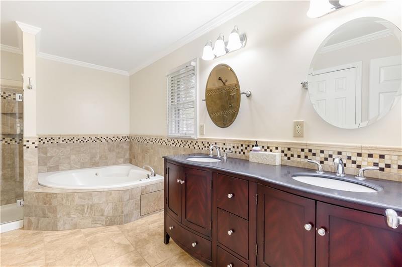 3890 Jim Owens Road Northwest Kennesaw, GA 30152 - Photo 28 of 43 a bathroom with a bathtub a sink and mirror