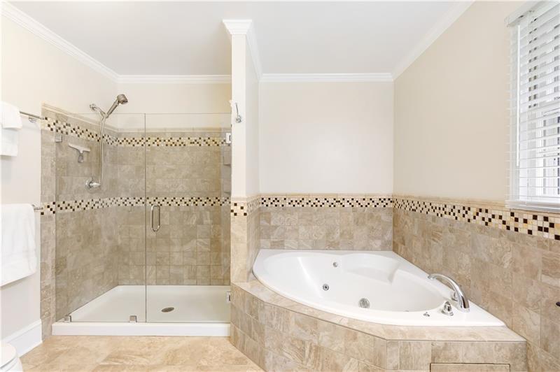 3890 Jim Owens Road Northwest Kennesaw, GA 30152 - Photo 29 of 43 a bathroom with a bathtub and a shower