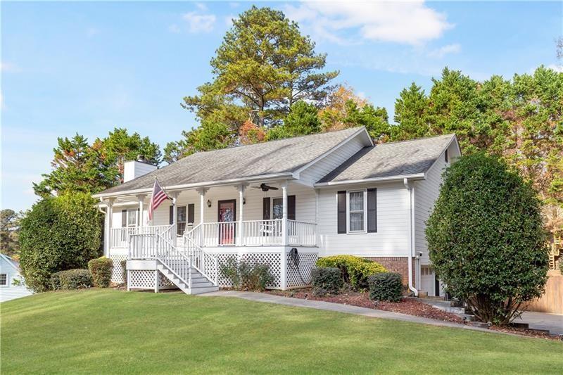 3890 Jim Owens Road Northwest Kennesaw, GA 30152 - Photo 3 of 43 a front view of a house with a yard