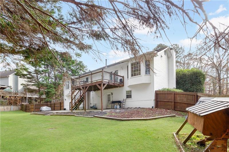 3890 Jim Owens Road Northwest Kennesaw, GA 30152 - Photo 40 of 43 a view of a house with backyard and a tree
