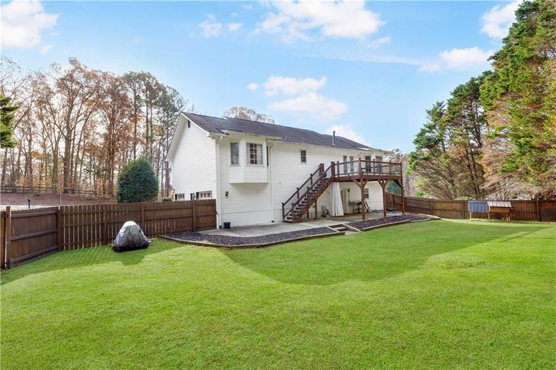 3890 Jim Owens Road Northwest Kennesaw, GA 30152 - Photo 43 of 43 a view of a house with backyard and trees