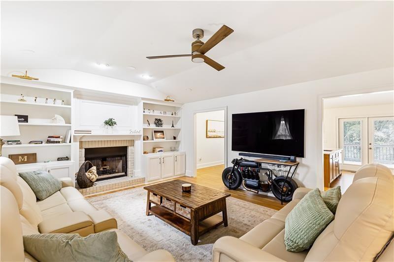 3890 Jim Owens Road Northwest Kennesaw, GA 30152 - Photo 5 of 43 a living room with furniture a fireplace and a flat screen tv