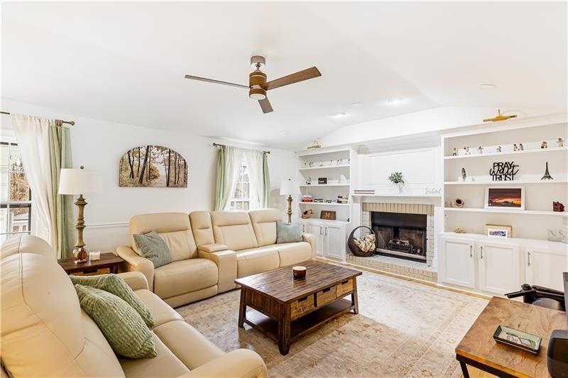 3890 Jim Owens Road Northwest Kennesaw, GA 30152 - Photo 6 of 43 a living room with furniture and a fireplace