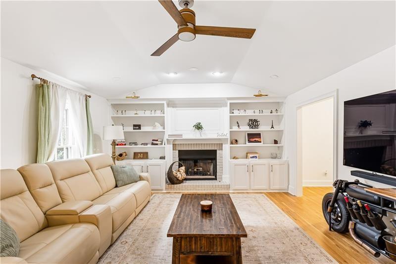 3890 Jim Owens Road Northwest Kennesaw, GA 30152 - Photo 9 of 43 a living room with furniture flat screen tv and a fireplace
