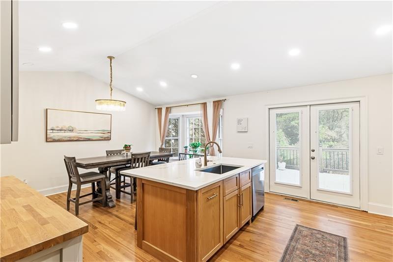 3890 Jim Owens Road Northwest Kennesaw, GA 30152 - Photo 10 of 43 a kitchen with a stove a refrigerator a dining table and chairs
