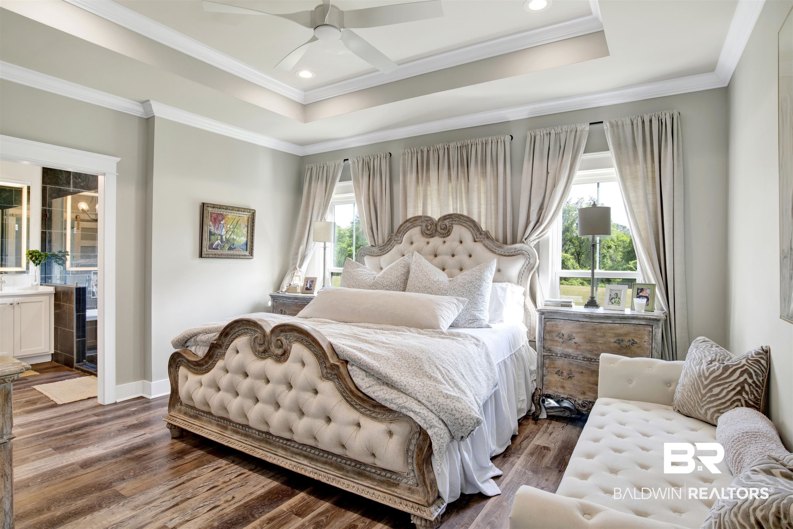 21621 Veranda Boulevard Fairhope, AL 36532 - Photo 13 of 51 Bedroom with crown molding, multiple windows, ensuite bathroom, and dark wood finished floors