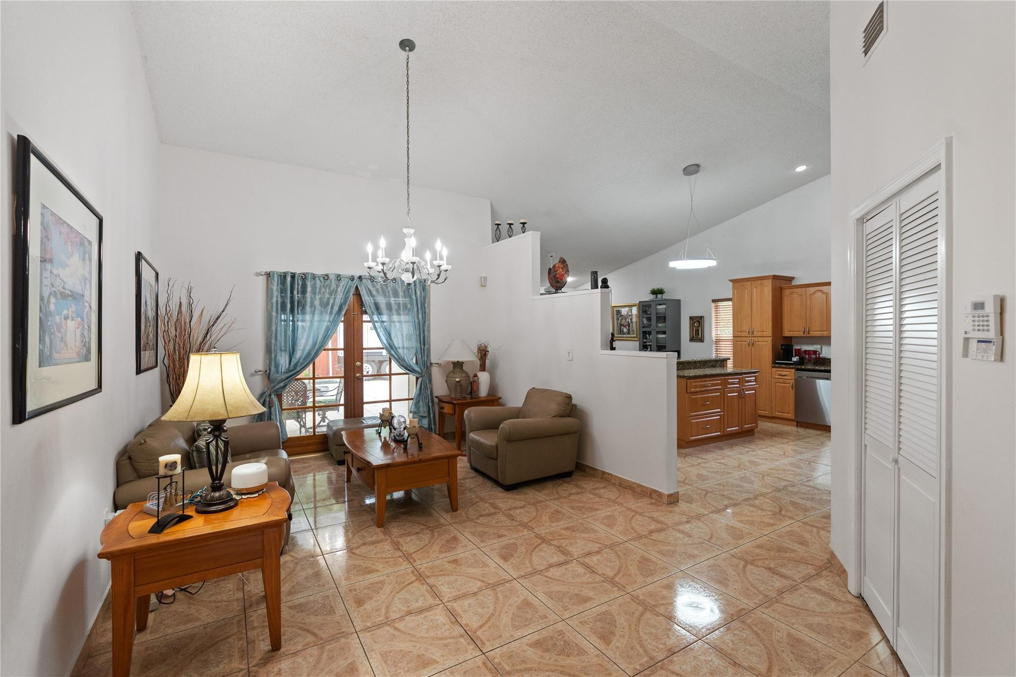 7440 Southwest 93rd Avenue Miami, FL 33173 - Photo 19 of 50 a living room with furniture a chandelier and kitchen view