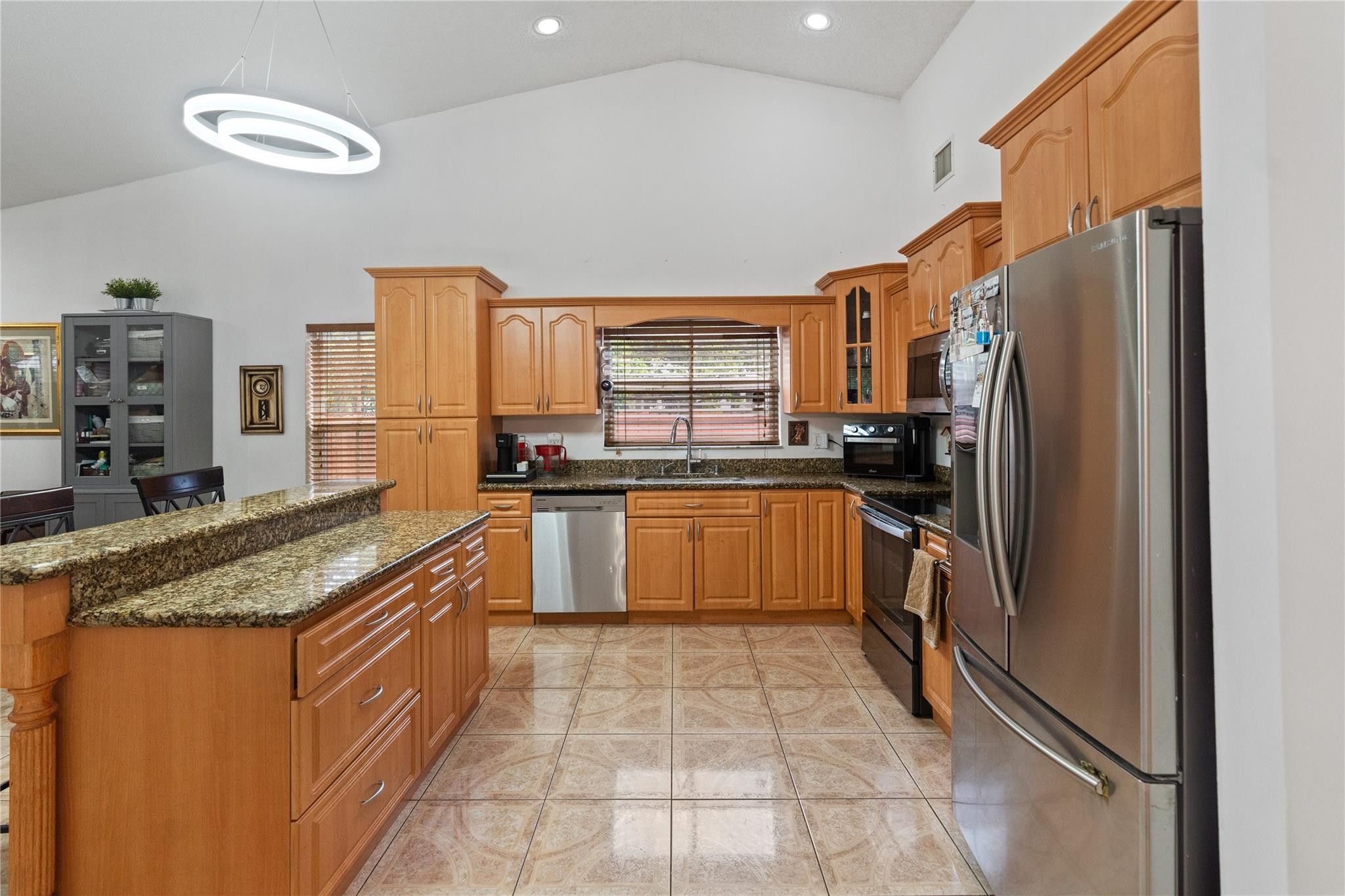 7440 Southwest 93rd Avenue Miami, FL 33173 - Photo 27 of 50 a kitchen with stainless steel appliances granite countertop a stove refrigerator and a sink