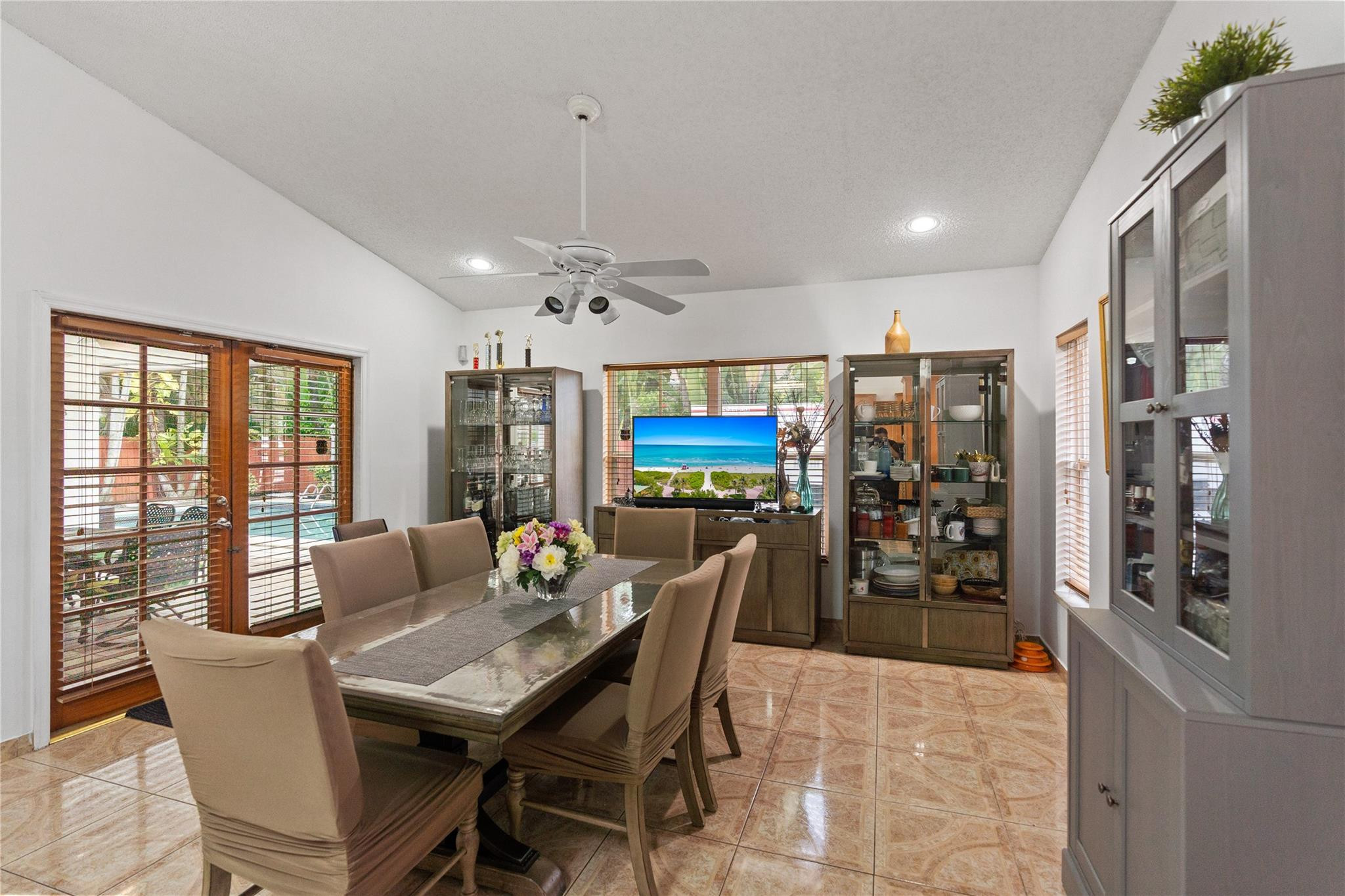 7440 Southwest 93rd Avenue Miami, FL 33173 - Photo 28 of 50 a dining room with furniture a rug a potted plant and a chandelier