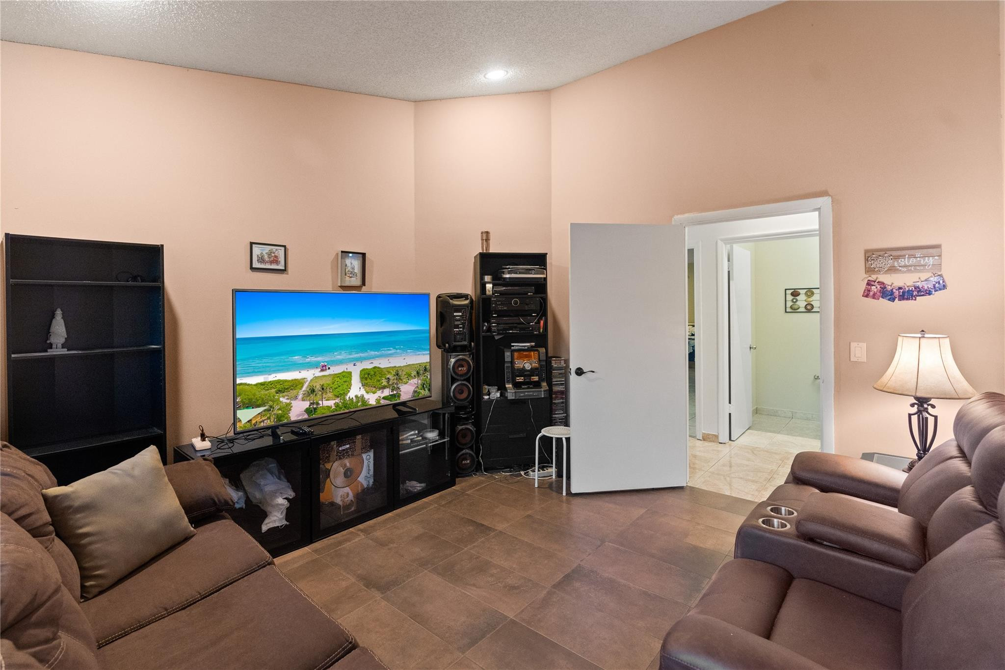7440 Southwest 93rd Avenue Miami, FL 33173 - Photo 35 of 50 a living room with furniture and a flat screen tv