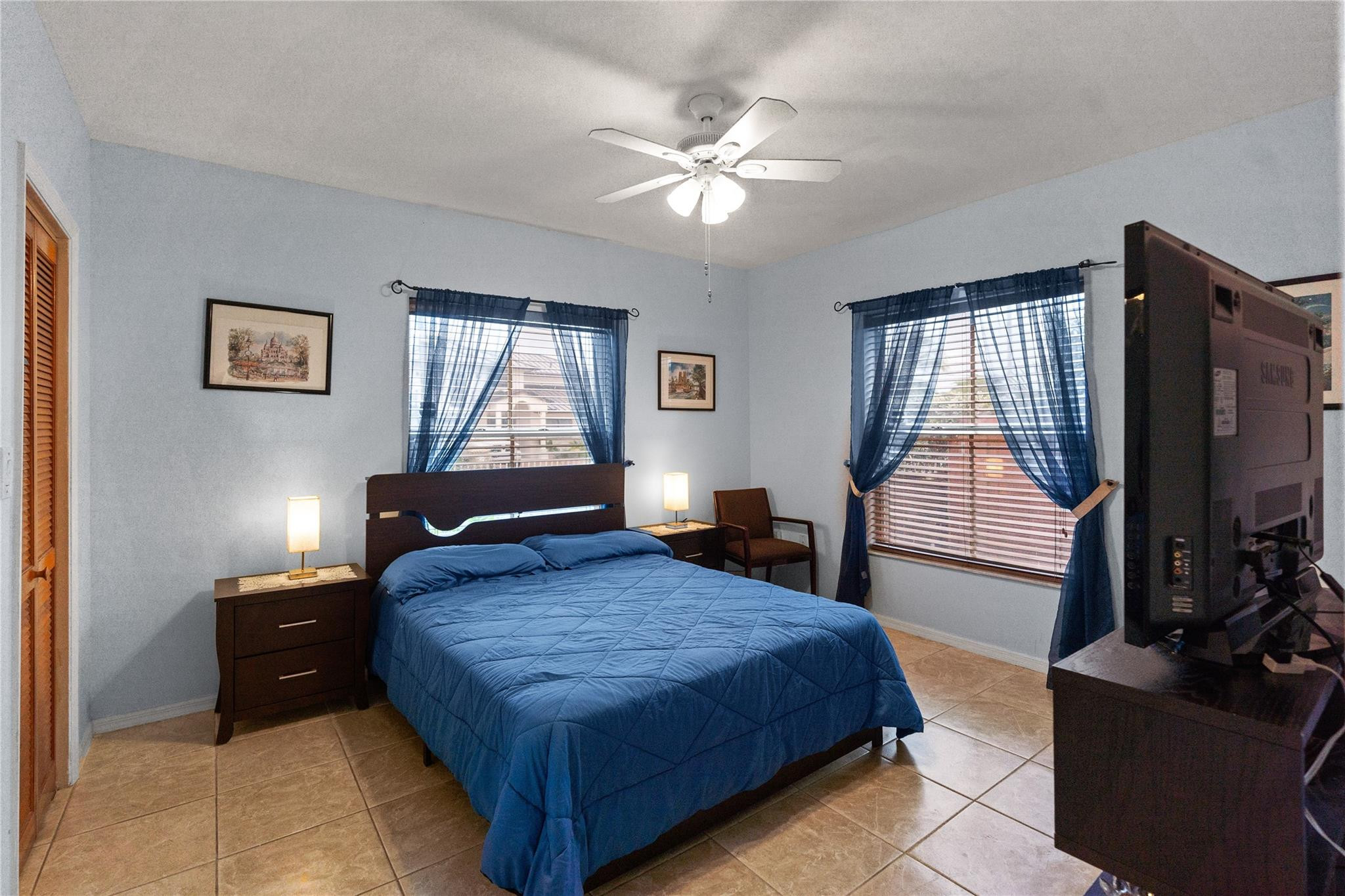 7440 Southwest 93rd Avenue Miami, FL 33173 - Photo 36 of 50 a bedroom with a bed and a flat tv screen on dresser