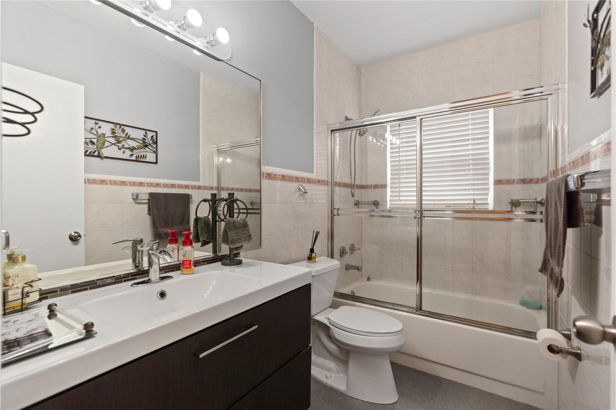 7440 Southwest 93rd Avenue Miami, FL 33173 - Photo 38 of 50 a bathroom with a double vanity sink toilet mirror and shower