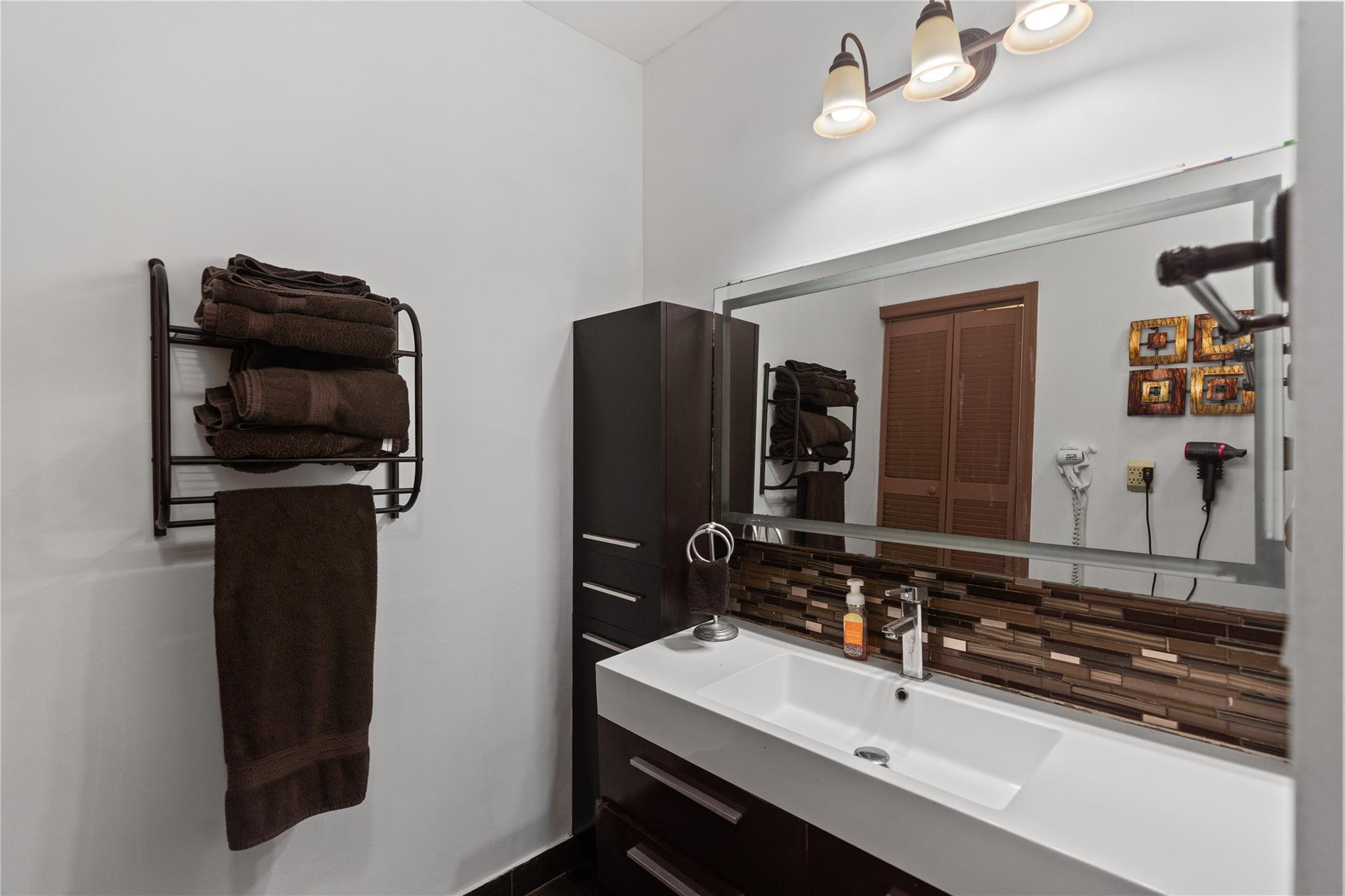 7440 Southwest 93rd Avenue Miami, FL 33173 - Photo 45 of 50 a bathroom with a sink and a mirror