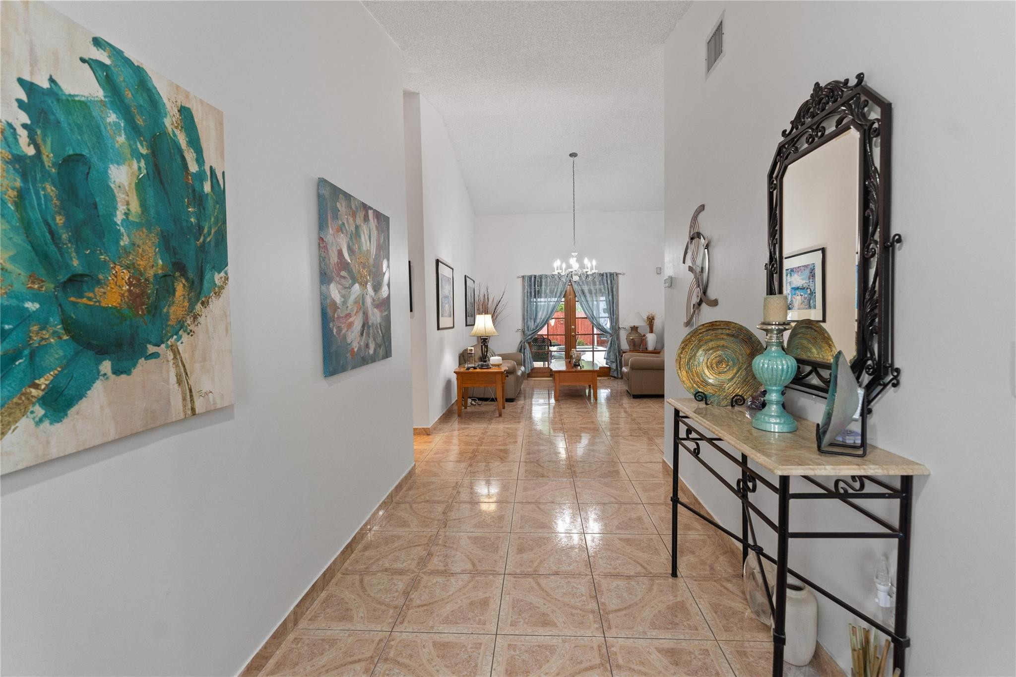 7440 Southwest 93rd Avenue Miami, FL 33173 - Photo 47 of 50 a hallway with a dining table and a chandelier
