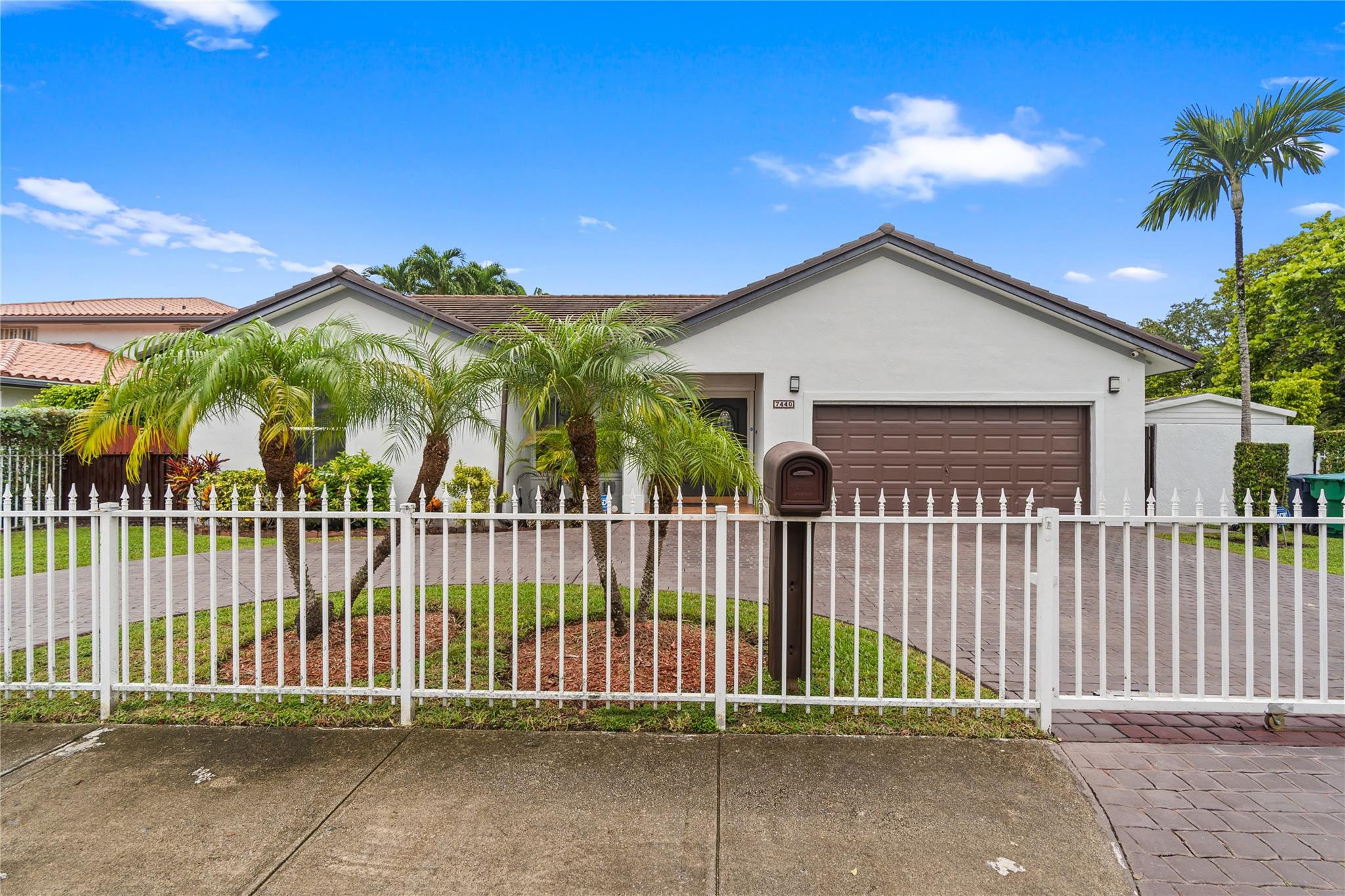 7440 Southwest 93rd Avenue Miami, FL 33173 - Photo 6 of 50 a view of a brick house with a small yard and plants