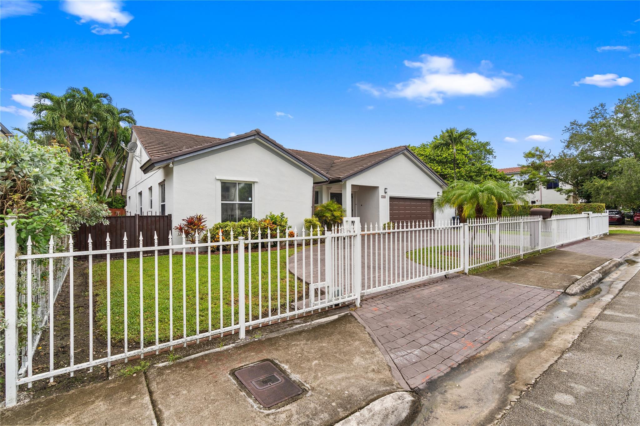 7440 Southwest 93rd Avenue Miami, FL 33173 - Photo 7 of 50 a view of a white house with a small yard and fence