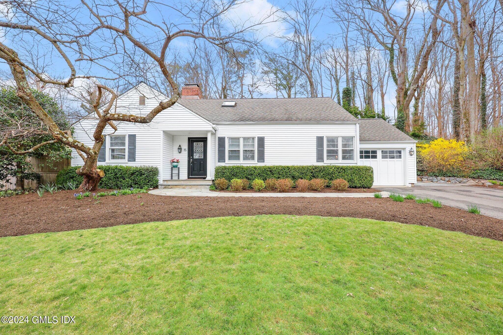 15 Glen Road Greenwich, CT 06830 - Photo 1 of 1 a front view of a house with a yard and potted plants