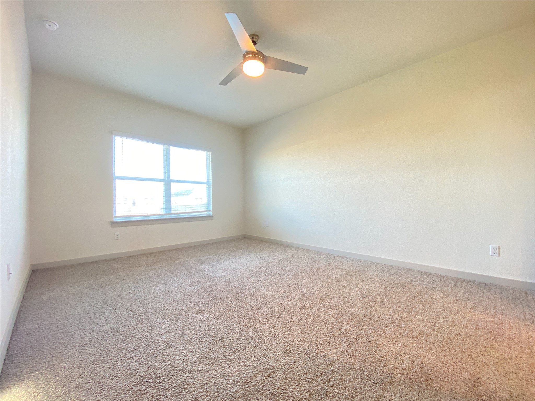 5121 Vanner Path Georgetown, TX 78626 - Photo 11 of 24 an empty room with a window and a ceiling fan