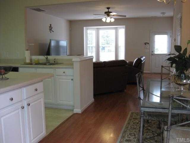 8131 Rhiannon Road Raleigh, NC 27613 - Photo 5 of 12 View of downstairs showing the open layout, laminate floors, 9 foot ceilings, and beautiful bay window in the family room.