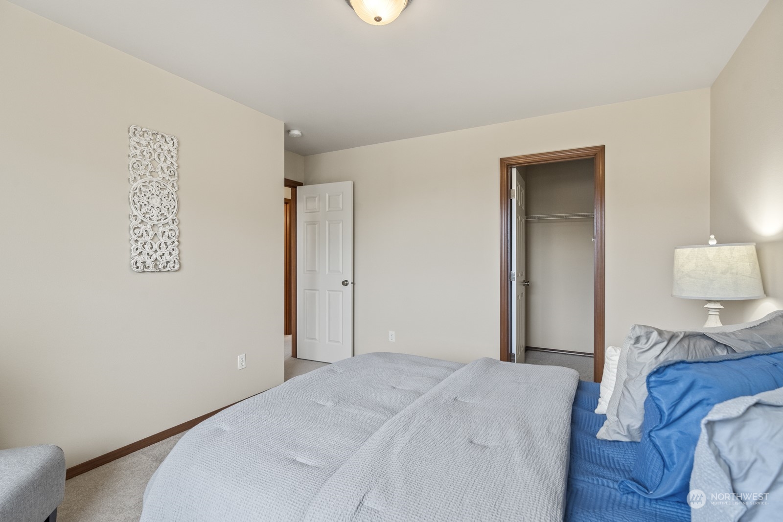 4608 146th Place Southeast Bothell, WA 98012 - Photo 29 of 39 a bedroom with a bed and a lamp
