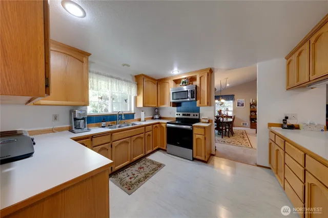 a kitchen with stainless steel appliances a refrigerator and a stove