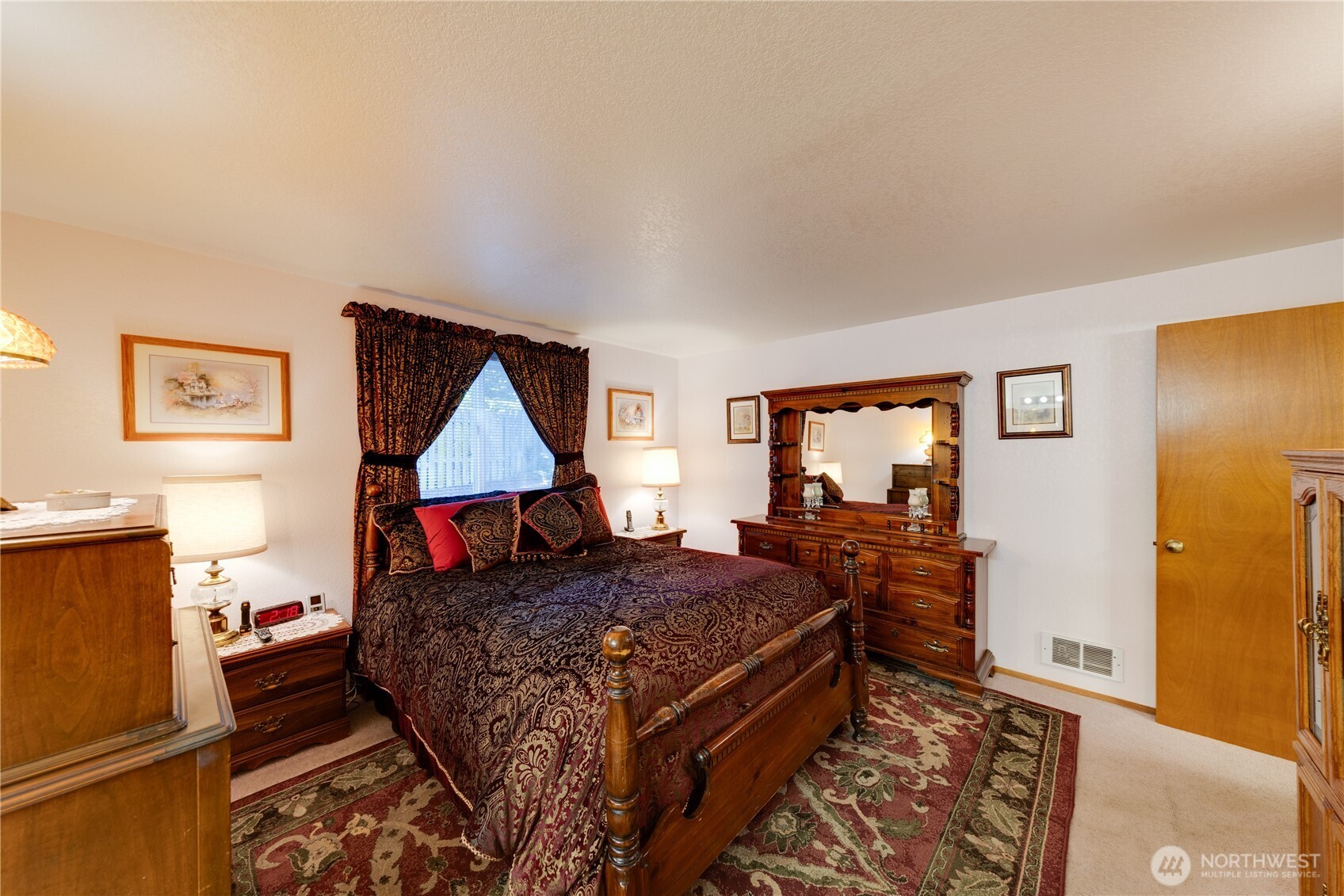 399 Tilingit Place La Conner, WA 98257 - Photo 16 of 39 a bedroom with a bed and wooden floor