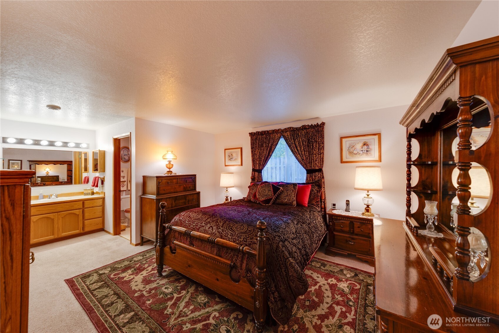 399 Tilingit Place La Conner, WA 98257 - Photo 18 of 39 a bedroom with a bed and a chandelier