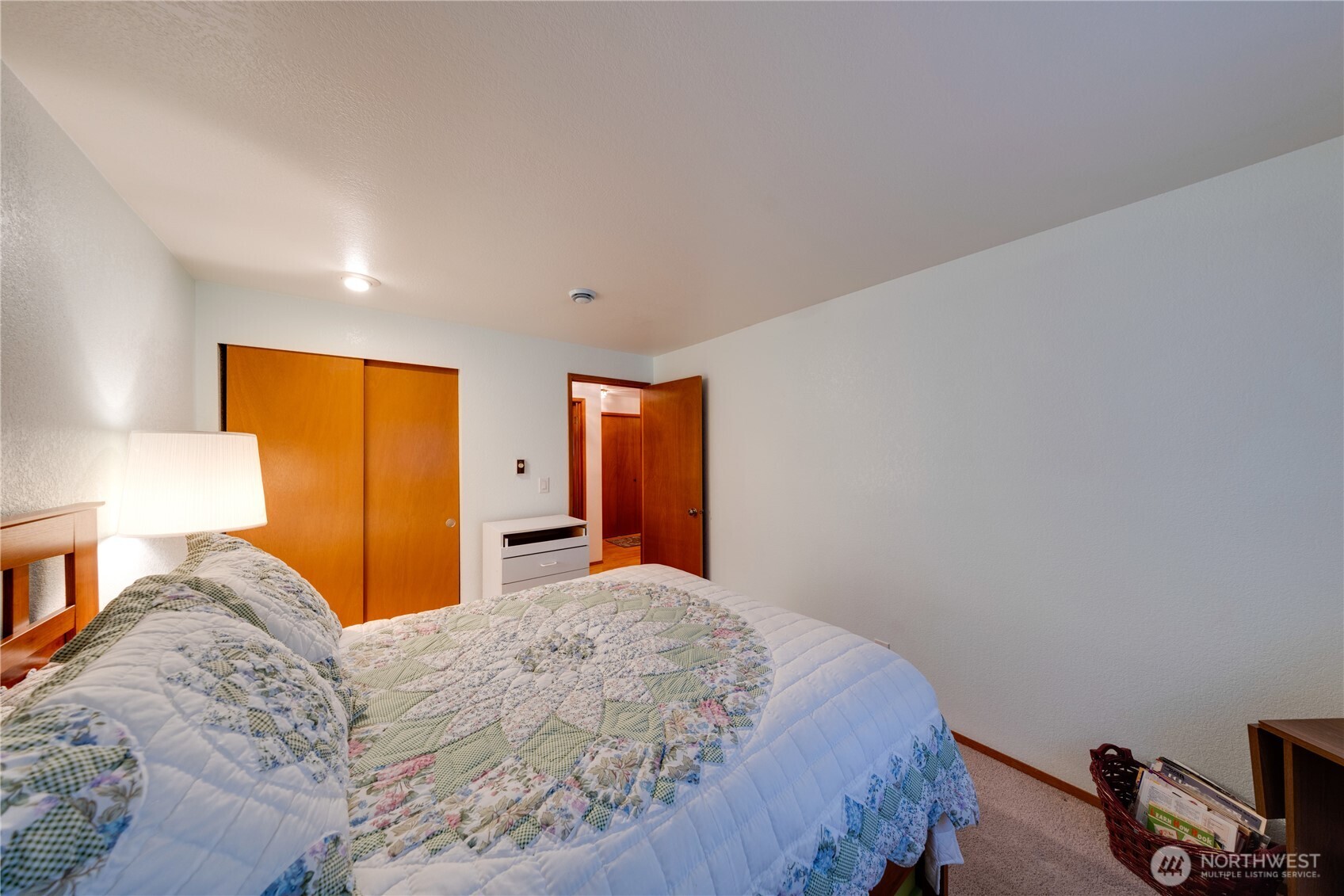 399 Tilingit Place La Conner, WA 98257 - Photo 21 of 39 a bedroom with a bed and a lamp