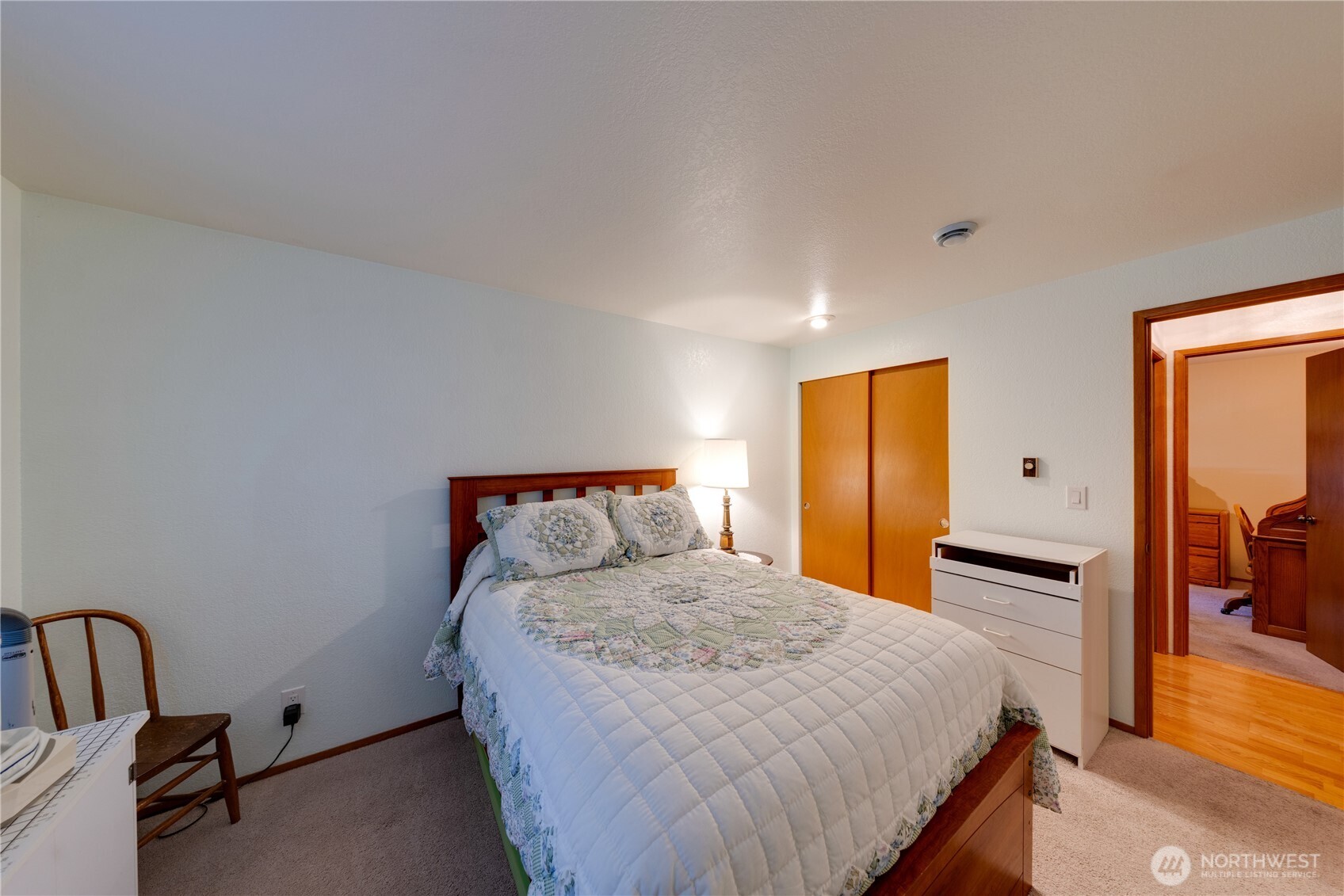 399 Tilingit Place La Conner, WA 98257 - Photo 22 of 39 a bedroom with a bed and a flat tv screen on dresser