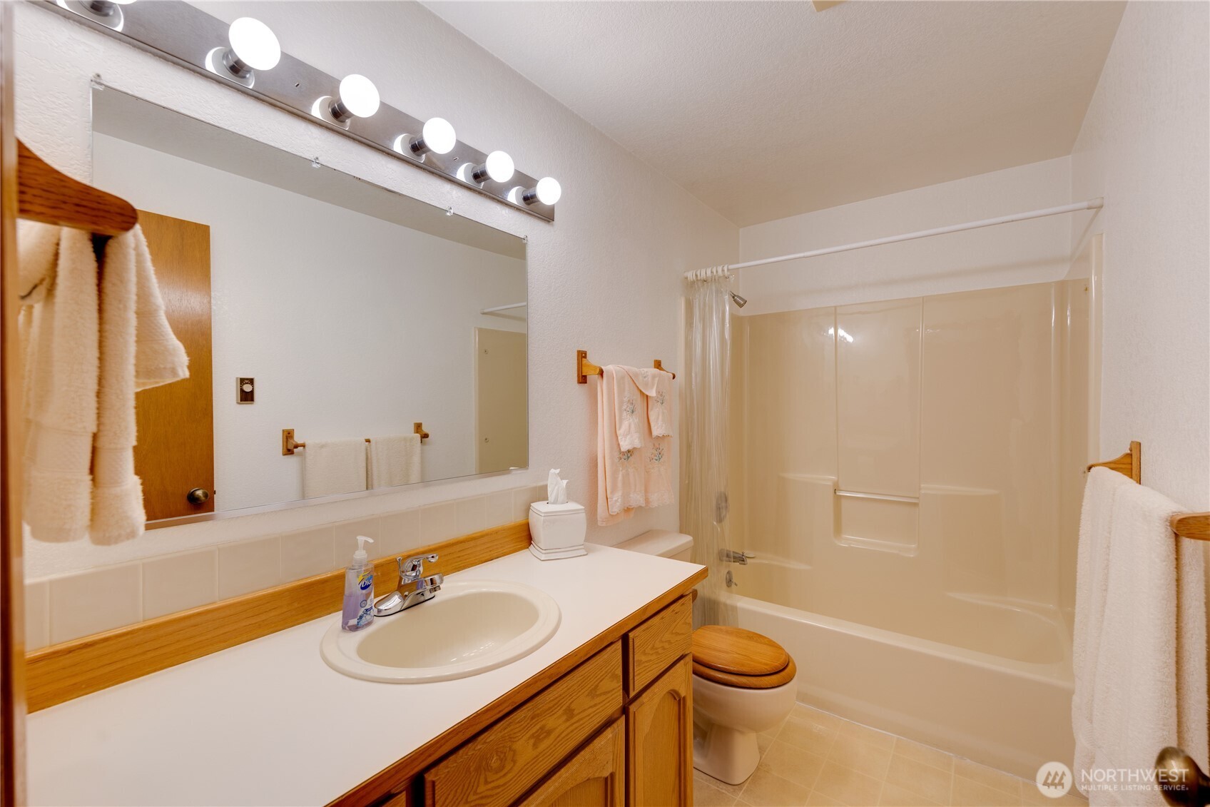 399 Tilingit Place La Conner, WA 98257 - Photo 24 of 39 a bathroom with a sink a toilet a mirror a vanity and shower
